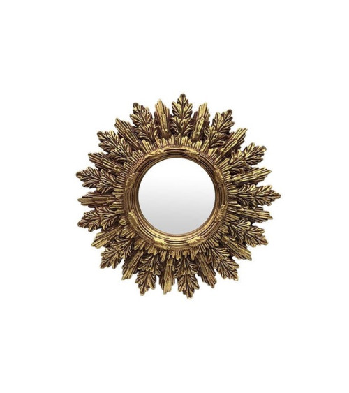 Miroir mural rond doré en forme de soleil accroché à un mur