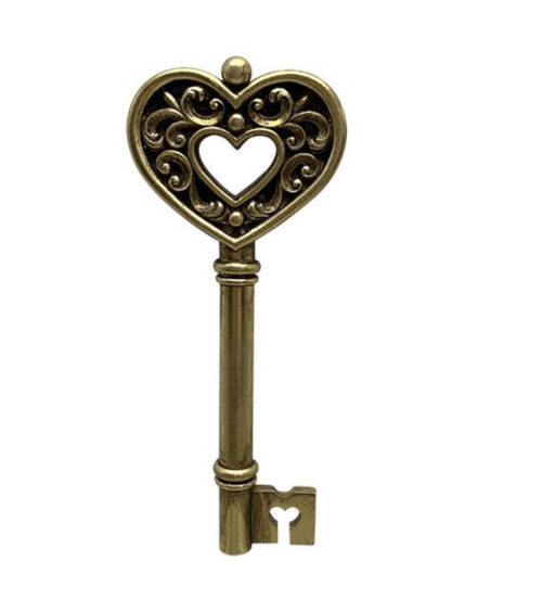 Décoration murale porte-bonheur : clé ancienne en résine dorée avec pommeau en forme de trèfle à quatre feuilles.