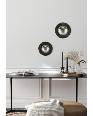 Miroir sorcière noir et doré dans une décoration murale élégante