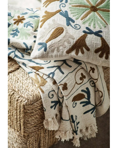 coussin brodé bohème sur canapé avec plaid texture naturelle