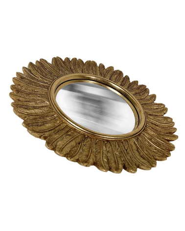 Vue de profil miroir convexe doré contours plume style miroir de sorcière