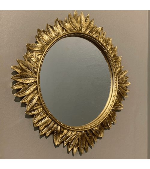 Miroir mural rond doré entouré de feuilles en relief