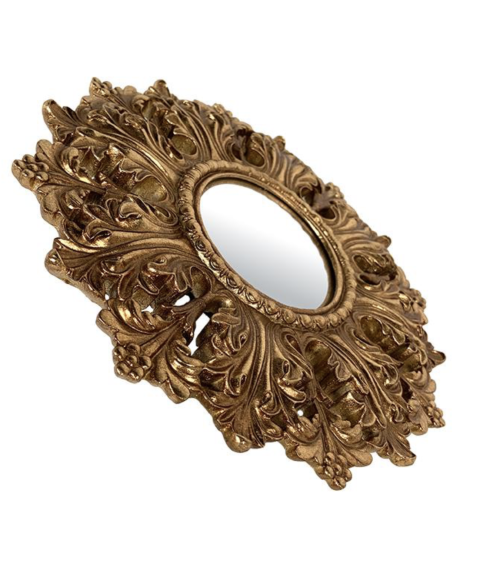 Détails des volutes sculptées du miroir convexe doré